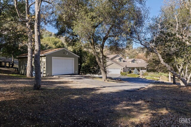 view of front of house with a garage and an outdoor structure