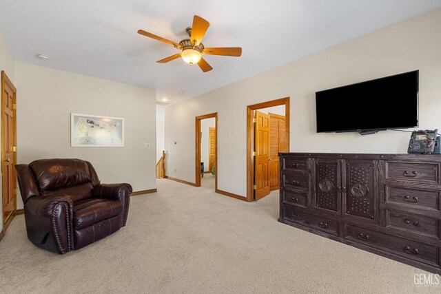 sitting room featuring light carpet and ceiling fan