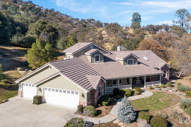 view of front of property featuring covered porch and a garage