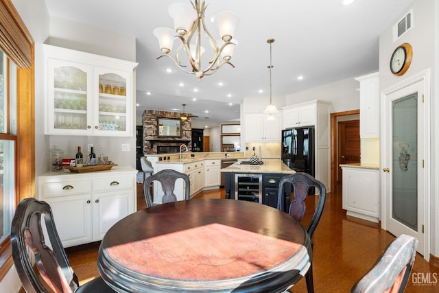 dining room with a chandelier, dark wood-type flooring, and beverage cooler