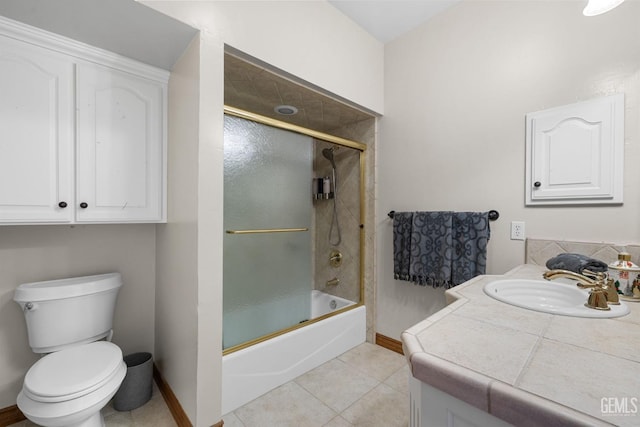 full bathroom featuring tile patterned floors, vanity, bath / shower combo with glass door, and toilet