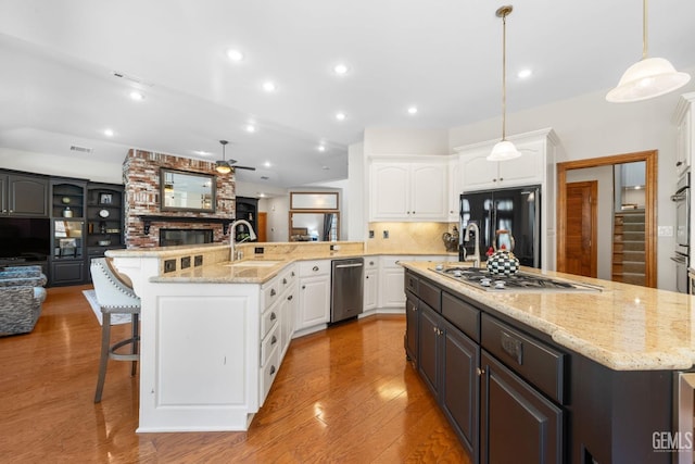 kitchen with a large island, white cabinetry, and stainless steel appliances