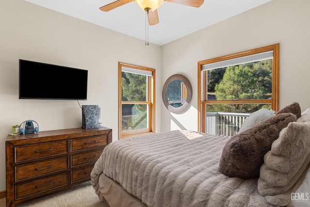 bedroom with ceiling fan and light carpet