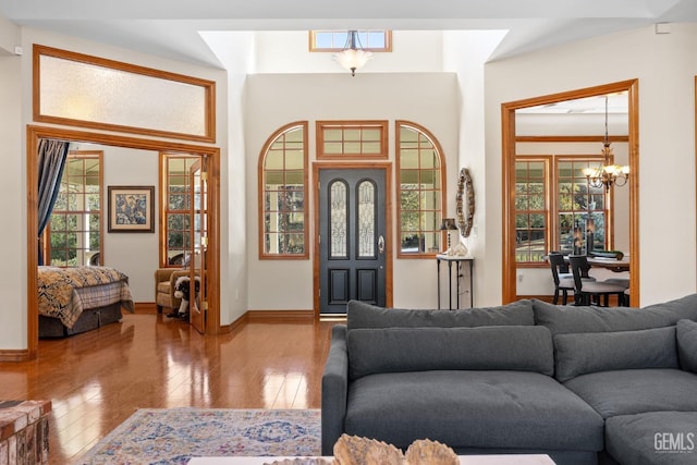 entryway featuring hardwood / wood-style floors and an inviting chandelier