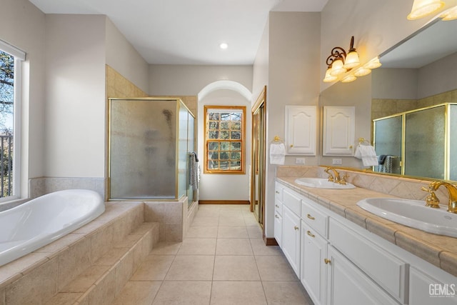 bathroom with tile patterned flooring, vanity, plenty of natural light, and independent shower and bath