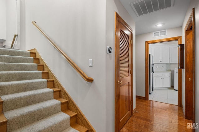 stairway featuring wood-type flooring