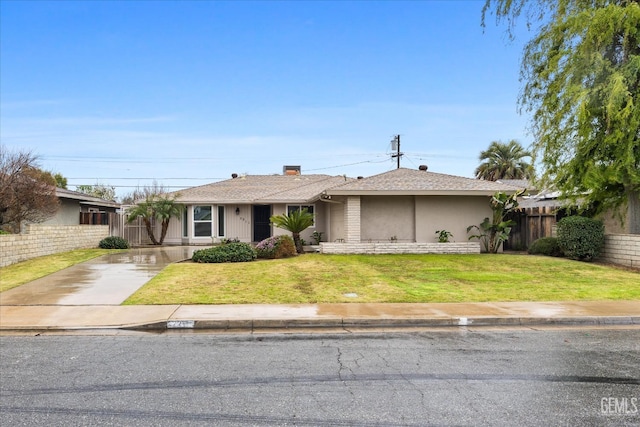 single story home with fence, driveway, a front lawn, and stucco siding