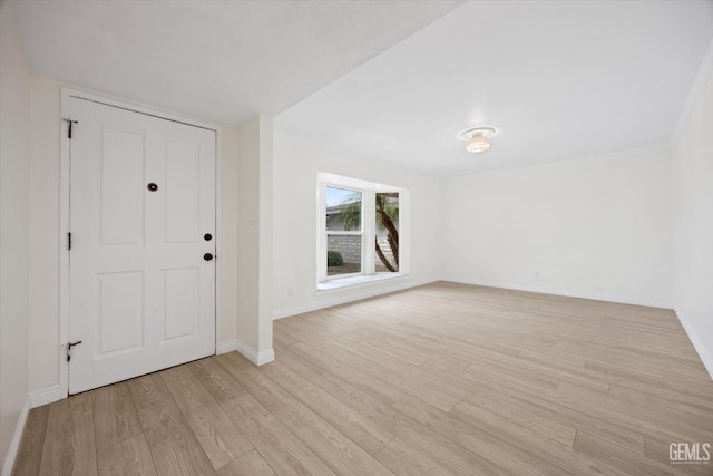 foyer entrance featuring light wood-type flooring and baseboards