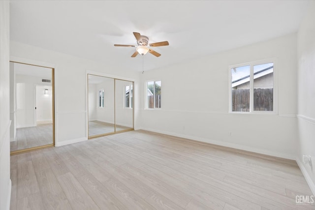 unfurnished bedroom featuring baseboards, visible vents, and light wood finished floors