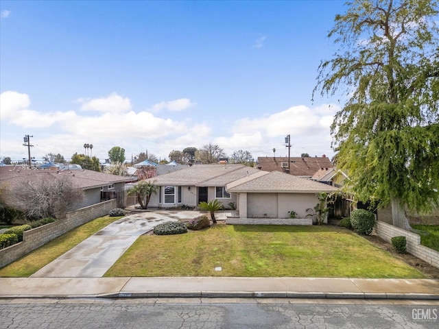 single story home featuring concrete driveway, a front yard, and fence