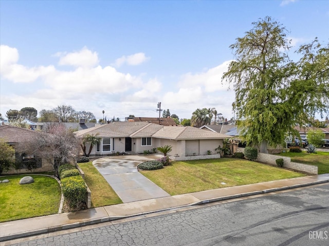 view of front of home with a garage, concrete driveway, and a front lawn