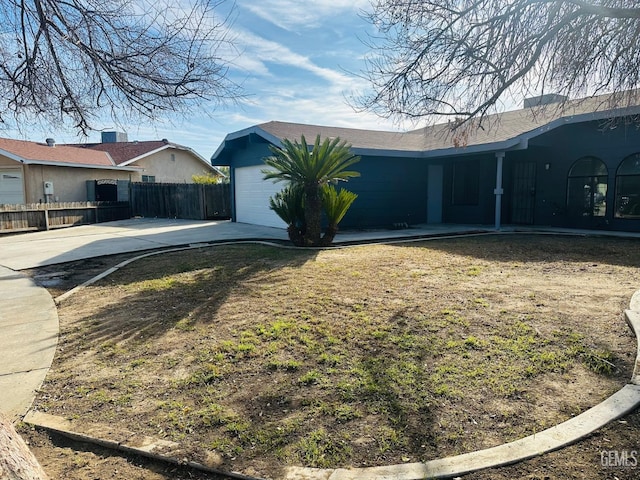 view of side of property with a garage and a yard