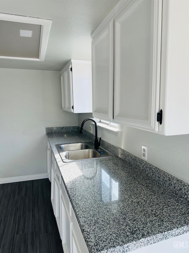 kitchen with white cabinetry, dark hardwood / wood-style flooring, sink, and a textured ceiling