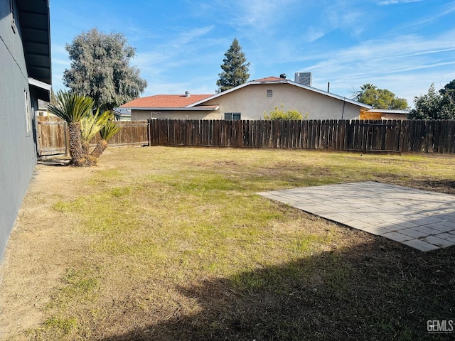 view of yard with central AC unit and a patio area