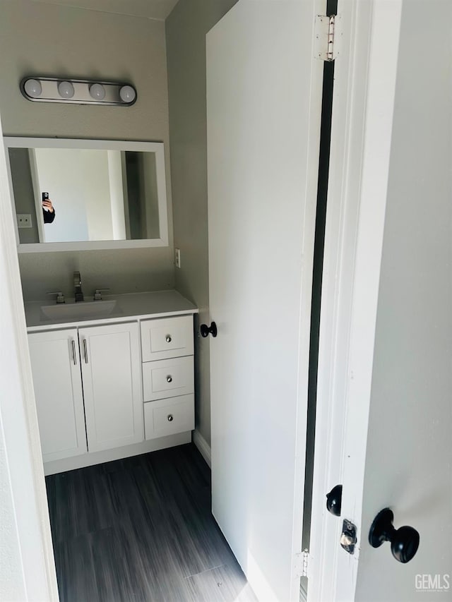 bathroom with vanity and hardwood / wood-style flooring