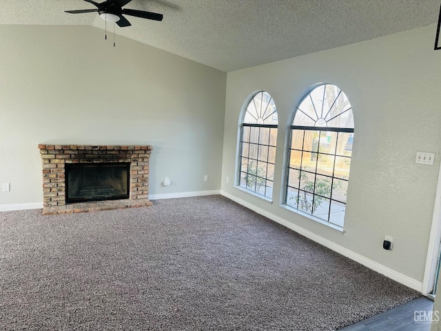 unfurnished living room featuring a fireplace, lofted ceiling, carpet, ceiling fan, and a textured ceiling