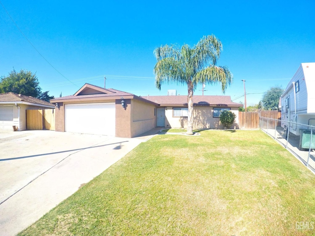 single story home featuring a front yard and a garage