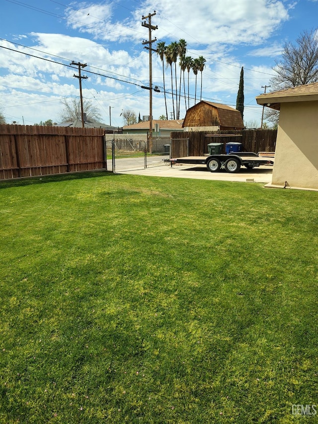 view of yard featuring fence and a gate