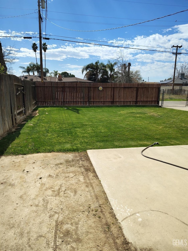 view of yard with a fenced backyard