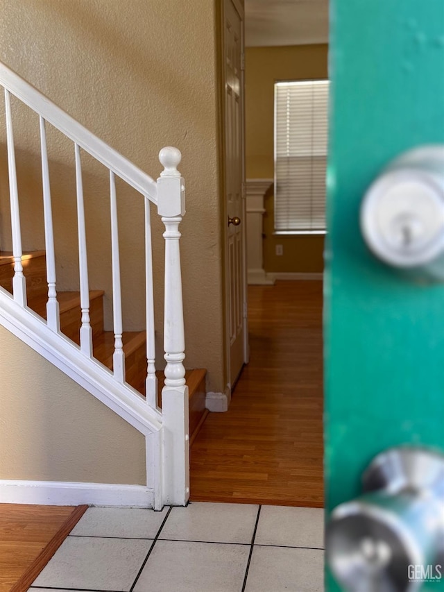 stairs featuring tile patterned floors