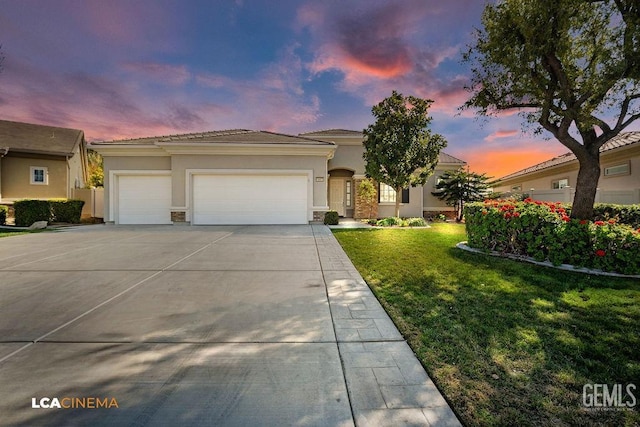 mediterranean / spanish-style home with a garage and a lawn