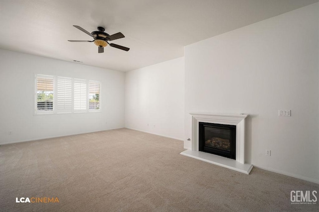 unfurnished living room featuring ceiling fan and light carpet