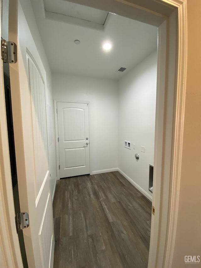 washroom with dark hardwood / wood-style floors and hookup for a washing machine