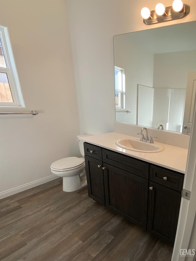 bathroom featuring hardwood / wood-style floors, toilet, and vanity