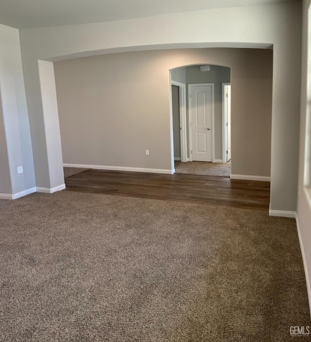 spare room featuring dark colored carpet