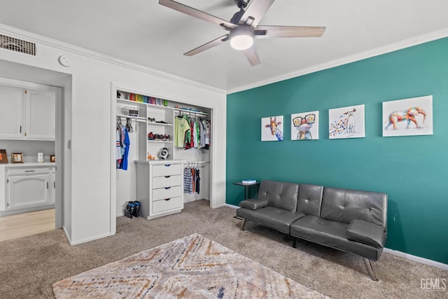 interior space featuring light colored carpet, ceiling fan, and ornamental molding