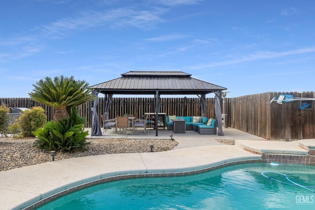 view of swimming pool with pool water feature, a patio area, a gazebo, and outdoor lounge area