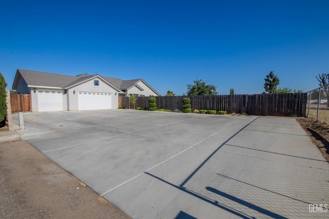 1850 Verdugo Ln, Bakersfield, CA 93312 - view of front of house featuring an attached garage, concrete driveway, and stucco siding