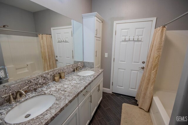 1850 Verdugo Ln, Bakersfield, CA 93312 - bathroom featuring shower / tub combo with curtain, double vanity, and wood tiled floors