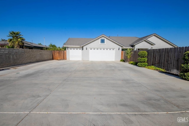 1850 Verdugo Ln, Bakersfield, CA 93312 - view of front of house with an attached garage, concrete driveway, stucco siding, and a tile roof