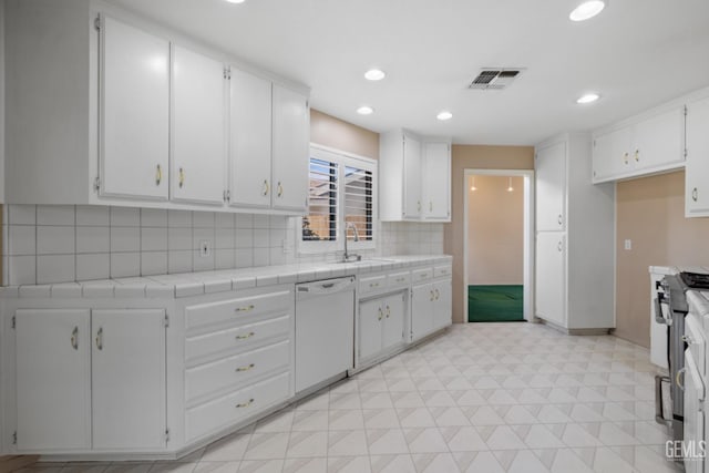 kitchen with visible vents, a sink, white cabinets, dishwasher, and stainless steel gas range