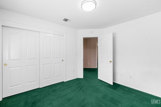 unfurnished bedroom featuring visible vents, carpet floors, and a closet