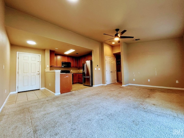 kitchen featuring light carpet, ceiling fan, and stainless steel refrigerator