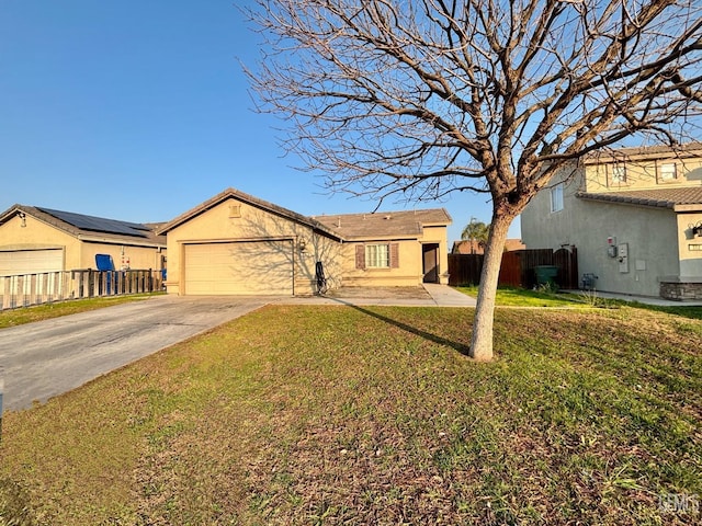 ranch-style home with a garage and a front yard