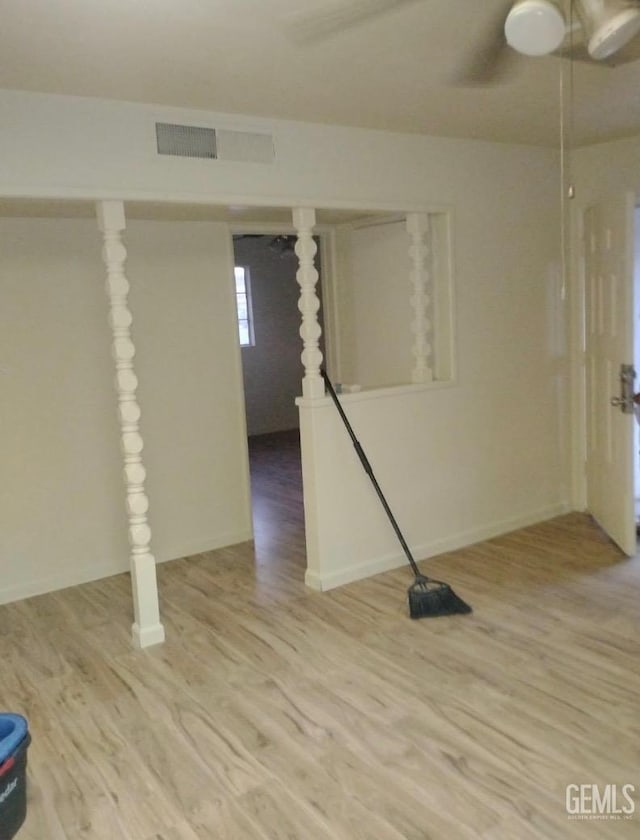 empty room with wood finished floors and visible vents