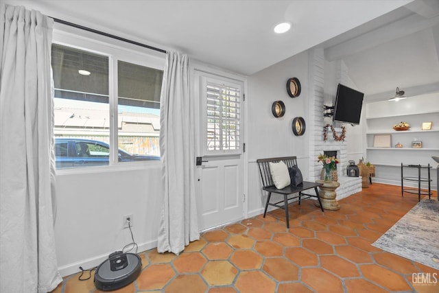 tiled foyer entrance featuring a fireplace