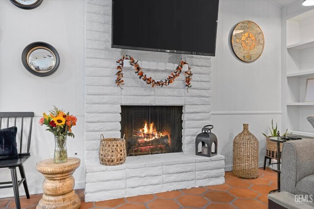 room details with built in shelves and a brick fireplace