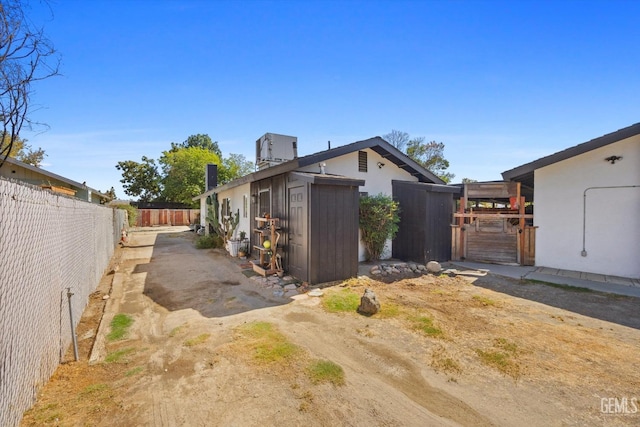 view of side of home featuring a storage unit