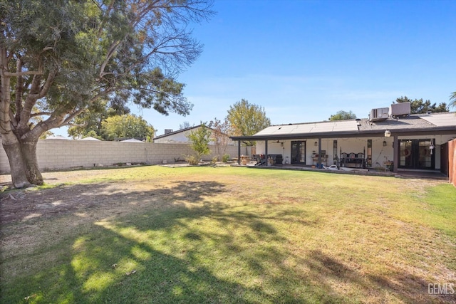 view of yard featuring cooling unit and a patio