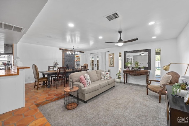 living room with ceiling fan with notable chandelier