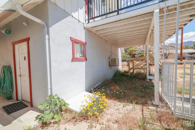view of side of home with a carport and stucco siding