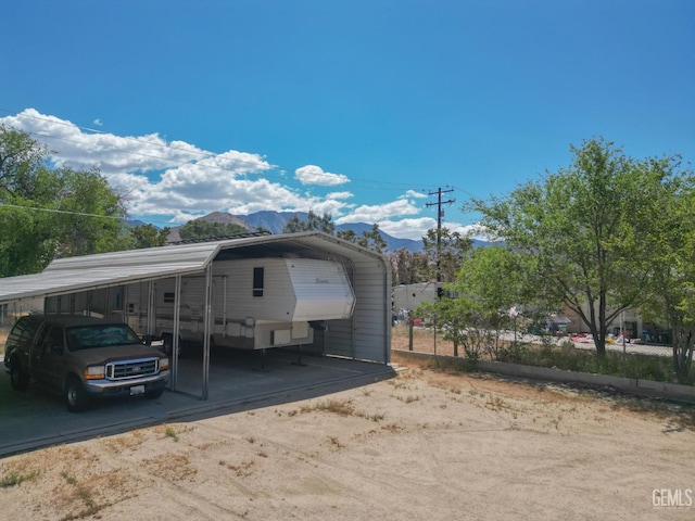 view of front of property with a detached carport and a mountain view