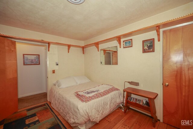 bedroom featuring wood-type flooring