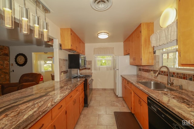 kitchen featuring dishwasher, stainless steel microwave, range with gas cooktop, a sink, and backsplash