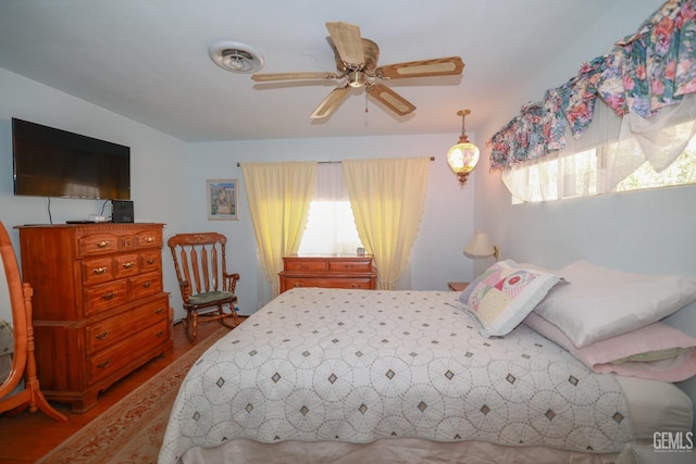 bedroom featuring visible vents and wood finished floors