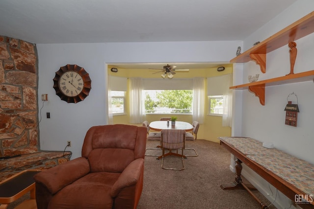 sitting room with a ceiling fan and carpet